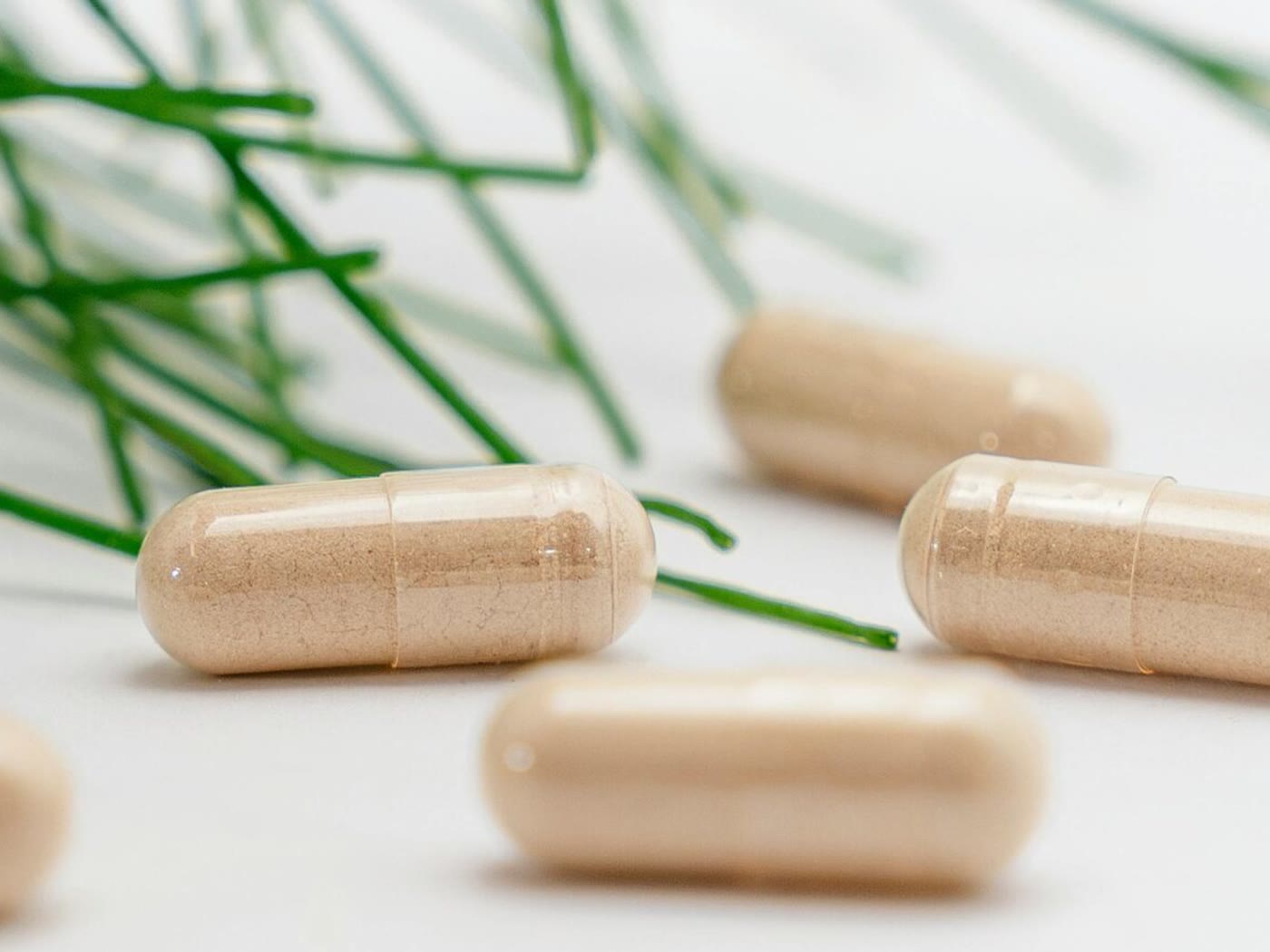 Nutraceutical capsules and supplement gummies displayed on a light background